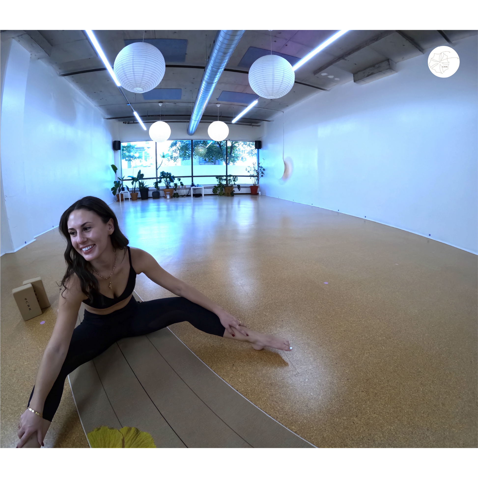 Pretty girl sitting on a yoga mat in a bright yoga studio 