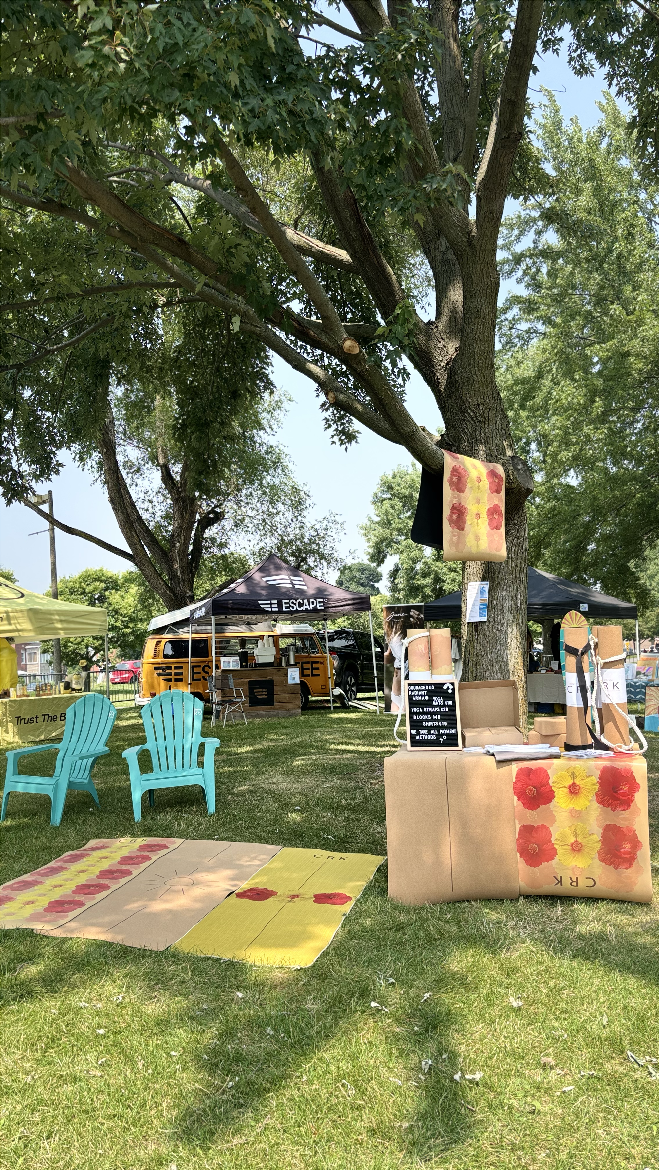 Crks vendor booth at a KSF and Taiga board event in the summer with a yoga mat hanging from a large tree